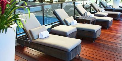 Relaxing indoor pool with lounge chairs at DoubleTree By Hilton Montreal.