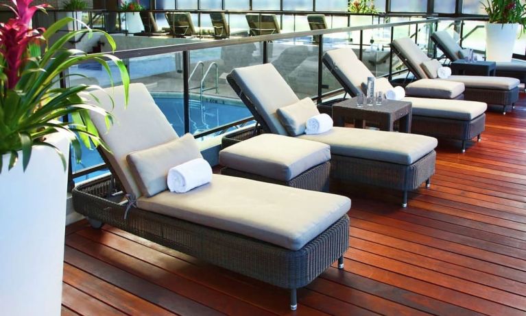 Relaxing indoor pool with lounge chairs at DoubleTree By Hilton Montreal.