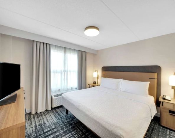 Standard day use room with king bed, work desk, TV and private bathroom at Homewood Suites By Hilton Toronto-Markham.