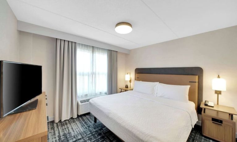 Standard day use room with king bed, work desk, TV and private bathroom at Homewood Suites By Hilton Toronto-Markham.