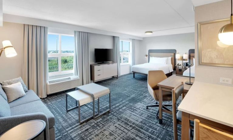 Twin day use room with lounge area and in-room kitchen at Homewood Suites By Hilton Toronto-Markham.