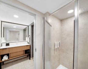 Private guest bathroom with shower and free toiletries at Homewood Suites By Hilton Toronto-Markham.