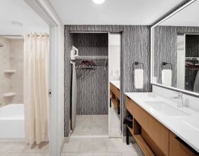 Private bathroom with tub, closet and free toiletries at Homewood Suites By Hilton Toronto-Markham.