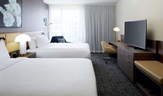 Day use twin room with TV, work desk and lounge area at Hilton Garden Inn Montreal Midtown.