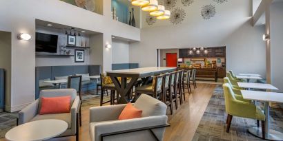 Hotel dining area with comfortable seating, perfect for co-working at Hampton Inn & Suites By Hilton Edmonton/West.