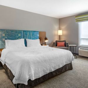 Standard day use room withking bed, TV, sofa and private bathroom at Hampton Inn & Suites By Hilton Edmonton/West.