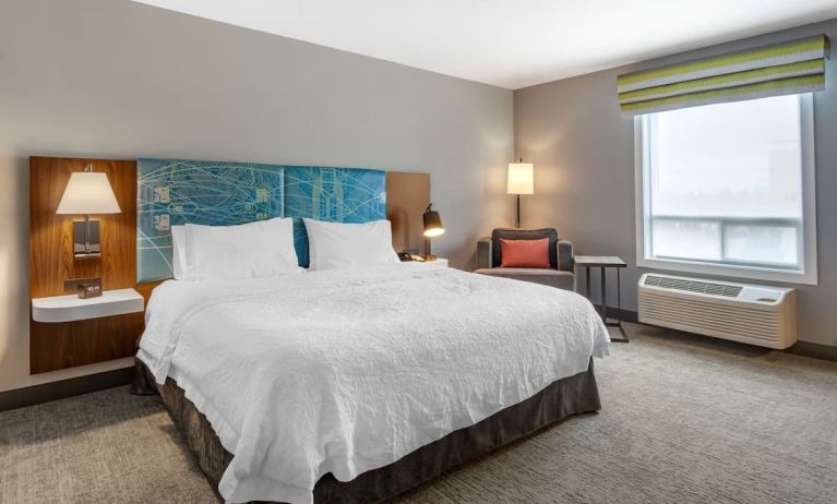 Standard day use room withking bed, TV, sofa and private bathroom at Hampton Inn & Suites By Hilton Edmonton/West.