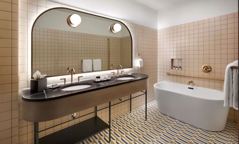 Private bathroom with tub and free toiletries at The Westley Calgary Downtown, Tapestry Collection By Hilton.