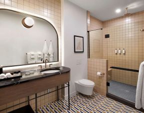 Private bathroom with shower and free toiletries at The Westley Calgary Downtown, Tapestry Collection By Hilton.