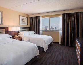 Twin day use room with TV and private bathroom at Hilton Winnipeg Airport Suites.