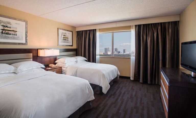 Twin day use room with TV and private bathroom at Hilton Winnipeg Airport Suites.