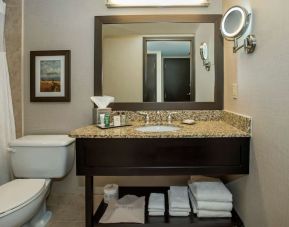 Private bathroom with shower and free toiletries at Hilton Winnipeg Airport Suites.