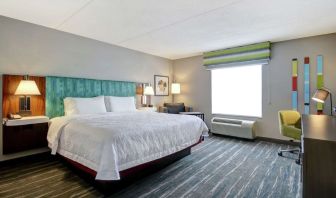 Bright day use room with king bed, work desk and private bathroom at the  Hampton Inn & Suites By Hilton Guelph.