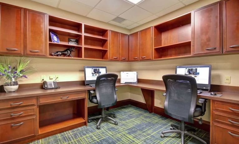 Professional business center with compuerts, printer and ergonomic chairs at the  Hampton Inn & Suites By Hilton Guelph.