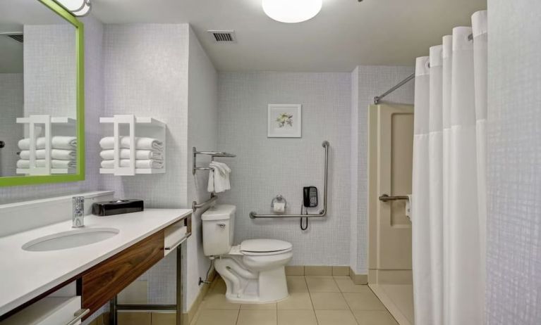 Private guest bathroom with shower and free toiletries at the  Hampton Inn & Suites By Hilton Guelph.