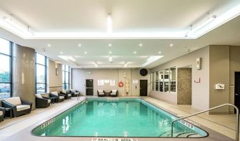 Relaxing indoor pool with lounge chairs at DoubleTree By Hilton Kitchener.