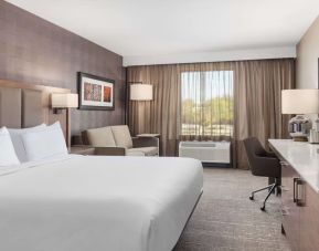 Day use room with TV, work desk, sofa and private bathroom at DoubleTree By Hilton Kitchener.