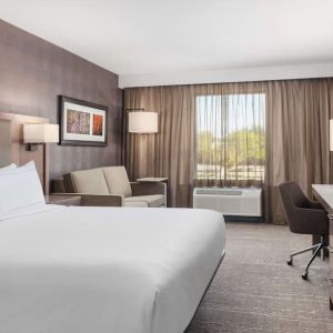 Day use room with TV, work desk, sofa and private bathroom at DoubleTree By Hilton Kitchener.