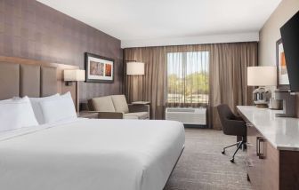 Day use room with TV, work desk, sofa and private bathroom at DoubleTree By Hilton Kitchener.