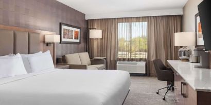 Day use room with TV, work desk, sofa and private bathroom at DoubleTree By Hilton Kitchener.