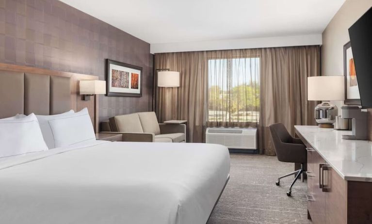 Day use room with TV, work desk, sofa and private bathroom at DoubleTree By Hilton Kitchener.