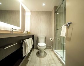 Private guest bathroom with shower and free toiletries at DoubleTree By Hilton Kitchener.