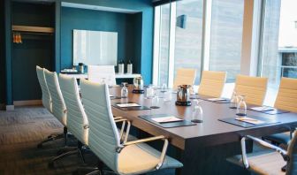 Professional meeting room with large windows, white board and comfortable chairs at the Hilton Garden Inn Fredericton.