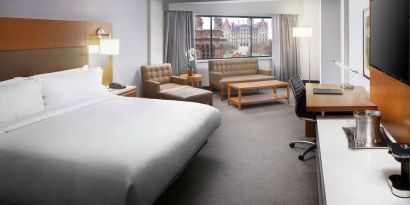 Day use room with work desk and sofa at Hilton Albany.
