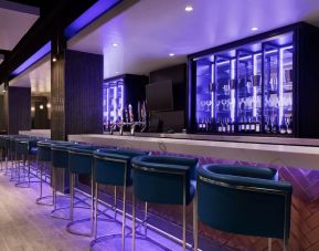 Hotel bar with lounge chairs at the Embassy Suites By Hilton Toronto Airport.