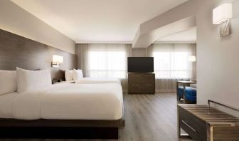 Day use twin room with TV screen, lounge area and work space at the Embassy Suites By Hilton Toronto Airport.