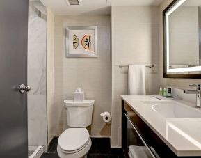 Private guest bathroom with shower and free toiletries at the Four Points By Sheraton St Catharines Niagara Suites. 