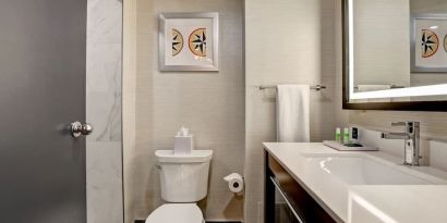 Private guest bathroom with shower and free toiletries at the Four Points By Sheraton St Catharines Niagara Suites. 