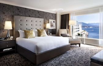 Day use room with TV, work desk, sofa and private bathroom at the Fairmont Waterfront.