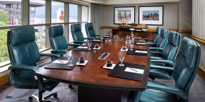 Professional meeting room with large windows and ergonomic chairs at the Fairmont Waterfront.