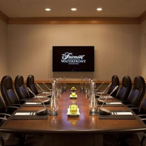 Professional meeting room with TV scree, and ergonomic chairs at the Fairmont Waterfront.