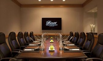 Professional meeting room with TV scree, and ergonomic chairs at the Fairmont Waterfront.