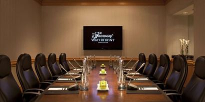 Professional meeting room with TV scree, and ergonomic chairs at the Fairmont Waterfront.