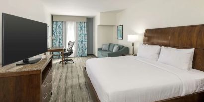 Day use room with work desk and sofa at Hilton Garden Inn Boca Raton.