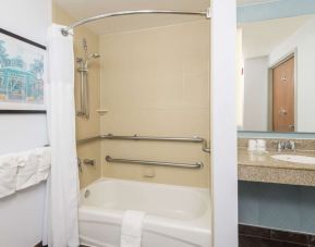 Guest bathroom with shower and tub at Hilton Garden Inn Boca Raton.