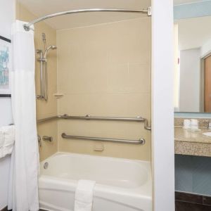 Guest bathroom with shower and tub at Hilton Garden Inn Boca Raton.