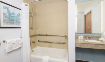 Guest bathroom with shower and tub at Hilton Garden Inn Boca Raton.