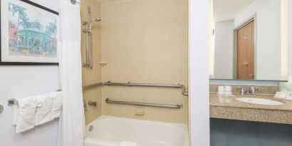 Guest bathroom with shower and tub at Hilton Garden Inn Boca Raton.