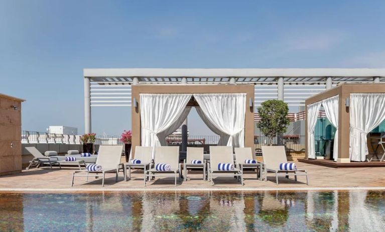 Sun loungers and cabanas available at Radisson Blu Hotel Dubai Media City.