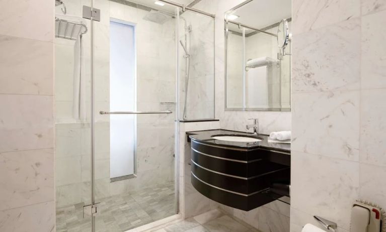 Guest bathroom with shower at Radisson Blu Hotel Dubai Media City.