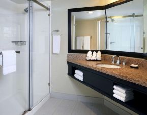 Guest bathroom with shower at Embassy Suites By Hilton LAX Airport North.