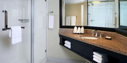 Guest bathroom with shower at Embassy Suites By Hilton LAX Airport North.