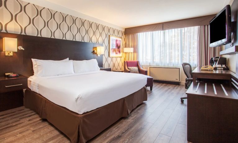 Day use room with TV, sofa, work desk and private bathroom at Holiday Inn Toronto International Airport. 