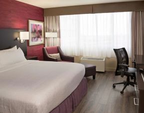 Day use room with king bed, sofa, TV, work desk and private bathroom at Holiday Inn Toronto International Airport.