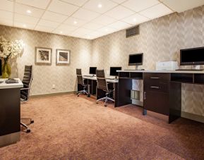 Professional business center with computers, printer and ergonomic chair at Holiday Inn Toronto International Airport.