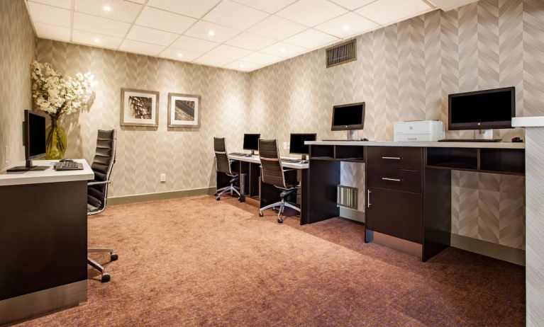 Professional business center with computers, printer and ergonomic chair at Holiday Inn Toronto International Airport.